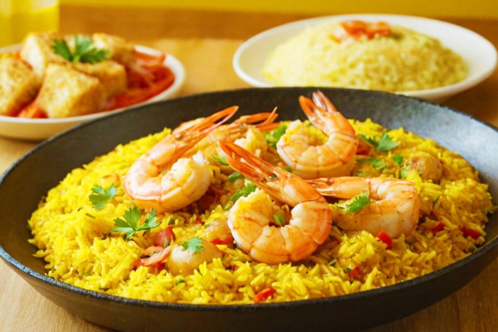 Assortment of seafood dishes with yellow rice.